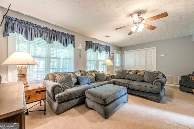 435 Flowering Trl, Grayson, GA 30017 - carpeted living area with a ceiling fan and a textured ceiling