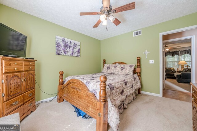435 Flowering Trl, Grayson, GA 30017 - bedroom featuring light carpet, a textured ceiling, baseboards, and ceiling fan