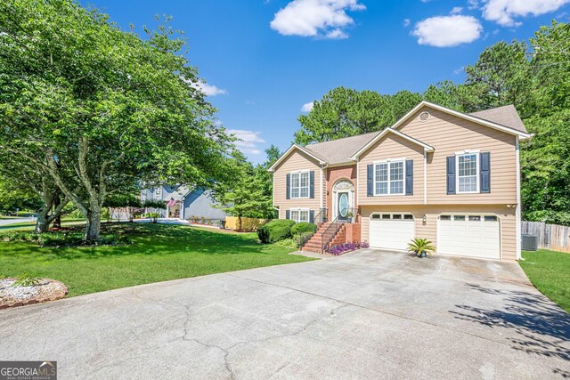 435 Flowering Trl, Grayson, GA 30017 - raised ranch featuring concrete driveway, a garage, and central AC unit