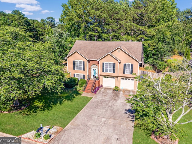 435 Flowering Trl, Grayson, GA 30017 - raised ranch with driveway, an attached garage, and a front lawn
