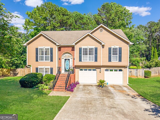 435 Flowering Trl, Grayson, GA 30017 - split foyer home featuring an attached garage, driveway, and roof with shingles