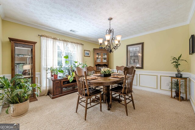435 Flowering Trl, Grayson, GA 30017 - dining room with light carpet, a chandelier, ornamental molding, wainscoting, and a textured ceiling