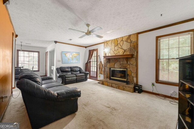 7281 Fernwood Dr, Riverdale, GA 30296 - carpeted living room with ceiling fan, ornamental molding, a fireplace, baseboards, and a textured ceiling