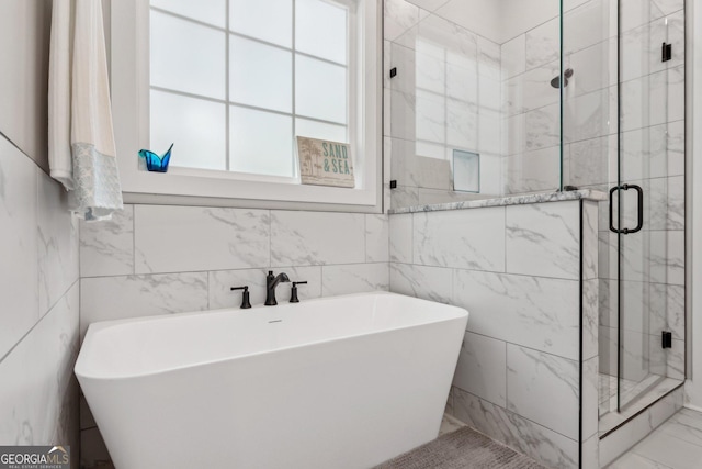 210 Birmingham Rd, Ball Ground, GA 30107 - full bathroom with a freestanding bath, a shower stall, marble look tiles, and tile walls