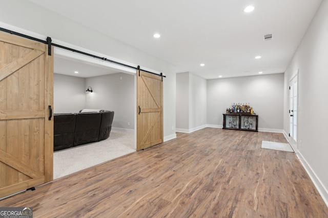 210 Birmingham Rd, Ball Ground, GA 30107 - below grade area with a barn door, wood finished floors, baseboards, and recessed lighting