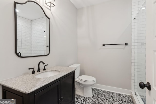 210 Birmingham Rd, Ball Ground, GA 30107 - bathroom with vanity, tiled shower, toilet, tile patterned flooring, and baseboards