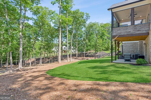 210 Birmingham Rd, Ball Ground, GA 30107 - view of grassy yard featuring a ceiling fan, a patio area, and central AC unit