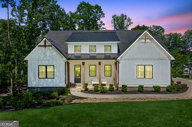 210 Birmingham Rd, Ball Ground, GA 30107 - modern farmhouse with covered porch, board and batten siding, a standing seam roof, and a lawn