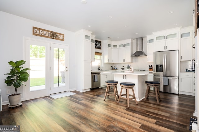 3537 Edenridge Ct, Buford, GA 30519 - kitchen with appliances with stainless steel finishes, wall chimney exhaust hood, a kitchen island, light countertops, and white cabinetry