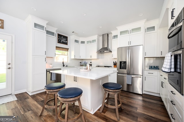 3537 Edenridge Ct, Buford, GA 30519 - kitchen with stainless steel appliances, wall chimney exhaust hood, a sink, a breakfast bar, and backsplash