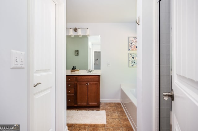 3537 Edenridge Ct, Buford, GA 30519 - bathroom with vanity, a bath, and baseboards