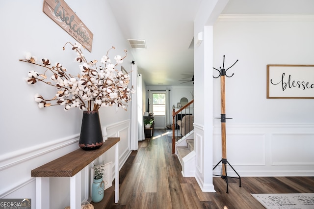 3537 Edenridge Ct, Buford, GA 30519 - hall featuring a decorative wall, stairs, dark wood-type flooring, wainscoting, and ornamental molding