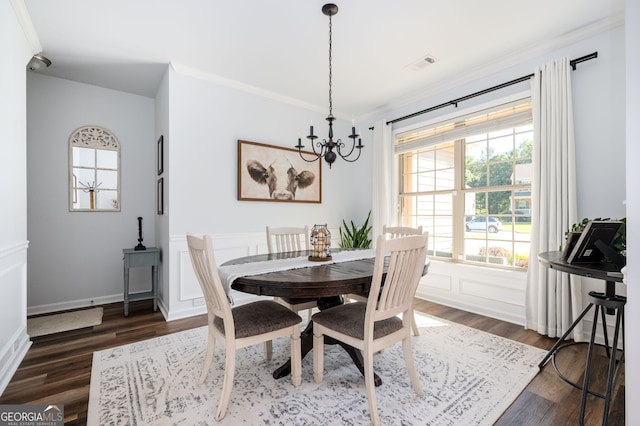 3537 Edenridge Ct, Buford, GA 30519 - dining room with a chandelier, dark wood-style floors, crown molding, and a wainscoted wall