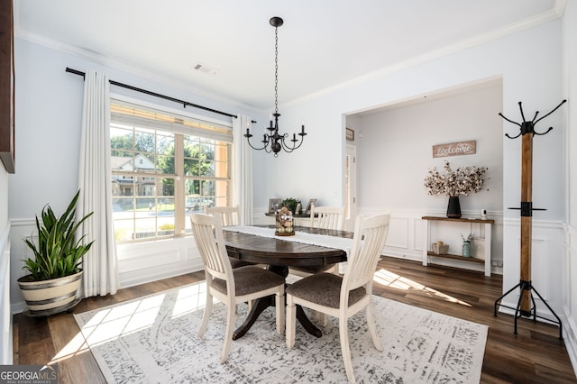 3537 Edenridge Ct, Buford, GA 30519 - dining room with ornamental molding, a chandelier, wood finished floors, wainscoting, and a decorative wall