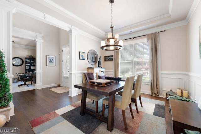 2470 Anderson Estates Ct, Marietta, GA 30064 - dining area with ornate columns, dark wood-type flooring, a chandelier, a wainscoted wall, and a decorative wall