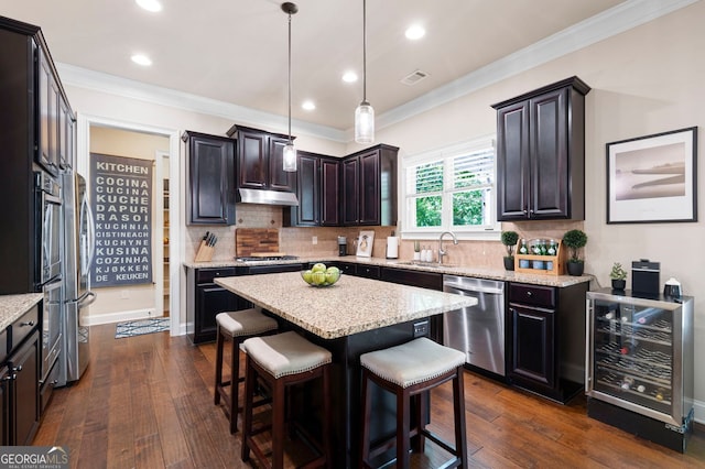 2470 Anderson Estates Ct, Marietta, GA 30064 - kitchen featuring stainless steel appliances, wine cooler, a kitchen island, backsplash, and a kitchen bar