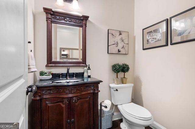 2470 Anderson Estates Ct, Marietta, GA 30064 - half bathroom with toilet, vanity, and baseboards