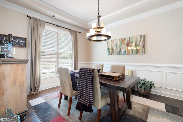 2470 Anderson Estates Ct, Marietta, GA 30064 - dining room featuring a chandelier, dark wood-type flooring, ornamental molding, a wainscoted wall, and a decorative wall