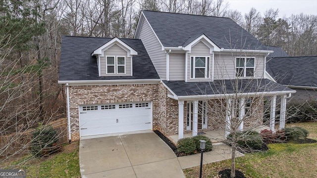217 Huntington Shoals Dr, Athens, GA 30606 - traditional-style house featuring concrete driveway, brick siding, a porch, an attached garage, and roof with shingles