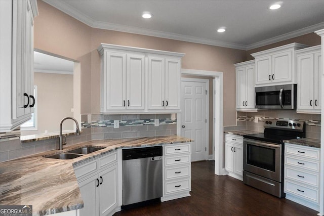 217 Huntington Shoals Dr, Athens, GA 30606 - kitchen with stainless steel appliances, a sink, decorative backsplash, white cabinetry, and ornamental molding