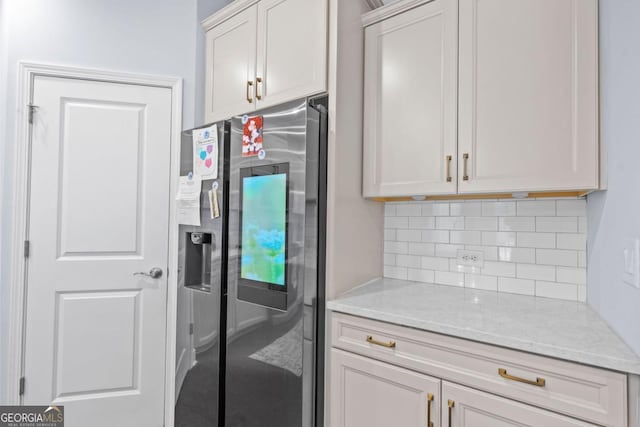 55 Clubhouse Way, Acworth, GA 30101 - kitchen with stainless steel fridge with ice dispenser, decorative backsplash, and light stone countertops