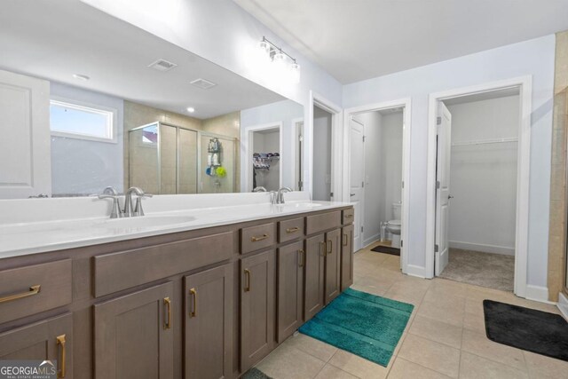 55 Clubhouse Way, Acworth, GA 30101 - bathroom featuring a spacious closet, a shower stall, tile patterned floors, and double vanity