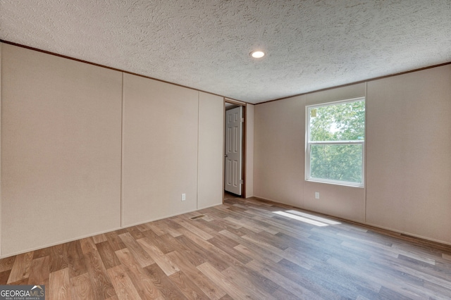 64 Town View Cir, Blairsville, GA 30512 - spare room with a textured ceiling, crown molding, and wood finished floors