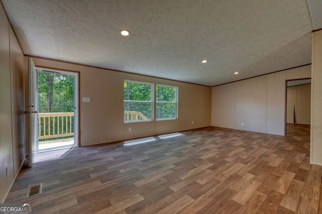 64 Town View Cir, Blairsville, GA 30512 - empty room with wood finished floors, a textured ceiling, healthy amount of natural light, crown molding, and recessed lighting