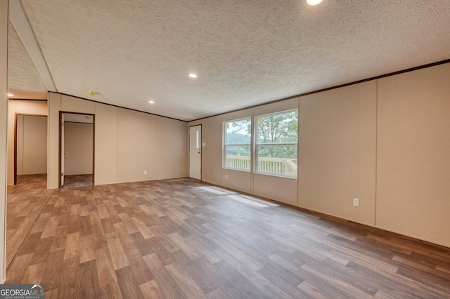 64 Town View Cir, Blairsville, GA 30512 - empty room featuring light wood finished floors, a textured ceiling, recessed lighting, and ornamental molding
