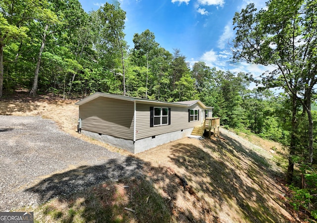 64 Town View Cir, Blairsville, GA 30512 - view of front facade featuring crawl space, gravel driveway, and a forest view