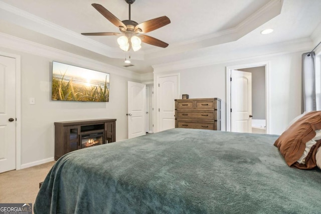 25 Grange Ct, Sharpsburg, GA 30277 - carpeted bedroom featuring a raised ceiling, ornamental molding, recessed lighting, a glass covered fireplace, and a ceiling fan