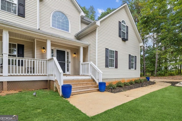 25 Grange Ct, Sharpsburg, GA 30277 - view of exterior entry with a lawn and covered porch