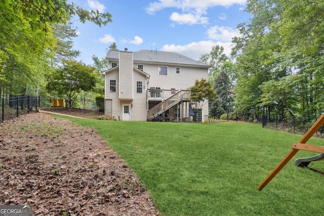 25 Grange Ct, Sharpsburg, GA 30277 - back of property with stairway, a fenced backyard, a deck, and a chimney