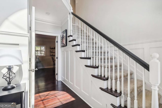 25 Grange Ct, Sharpsburg, GA 30277 - stairs featuring wood finished floors, a decorative wall, crown molding, and wainscoting