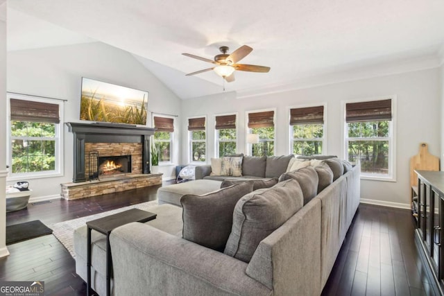 25 Grange Ct, Sharpsburg, GA 30277 - living area with a ceiling fan, plenty of natural light, a stone fireplace, vaulted ceiling, and dark wood-type flooring
