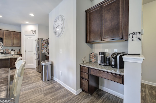 79 Mercer Ln, Cartersville, GA 30120 - kitchen featuring wood finished floors, dark brown cabinetry, freestanding refrigerator, light stone counters, and recessed lighting