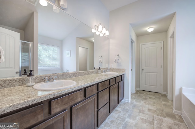79 Mercer Ln, Cartersville, GA 30120 - bathroom featuring double vanity, baseboards, a bath, an enclosed shower, and stone finish flooring