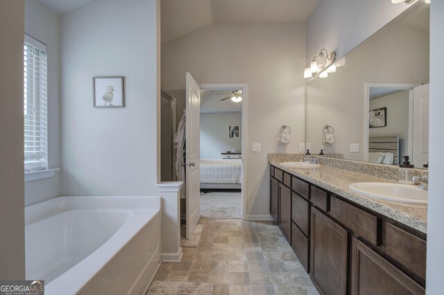 79 Mercer Ln, Cartersville, GA 30120 - ensuite bathroom with healthy amount of natural light, ceiling fan, double vanity, a bath, and vaulted ceiling