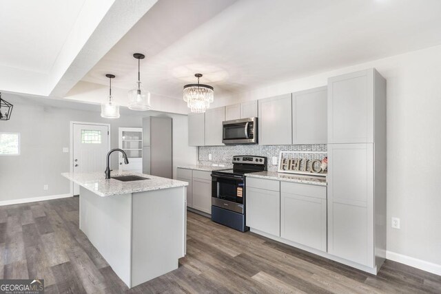 108 Holly St, Warner Robins, GA 31093 - kitchen with stainless steel appliances, a sink, backsplash, baseboards, and dark wood-style flooring
