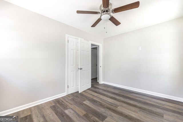 108 Holly St, Warner Robins, GA 31093 - unfurnished bedroom with baseboards, dark wood-style flooring, and ceiling fan