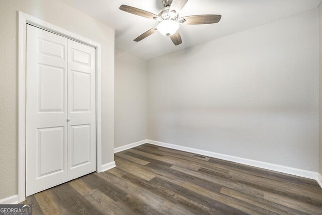 108 Holly St, Warner Robins, GA 31093 - unfurnished bedroom featuring baseboards, dark wood-style flooring, a closet, and a ceiling fan