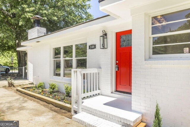 108 Holly St, Warner Robins, GA 31093 - doorway to property featuring a chimney and brick siding