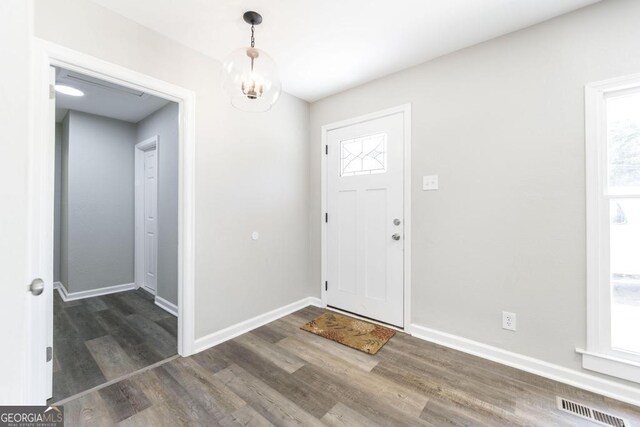 108 Holly St, Warner Robins, GA 31093 - entryway with wood finished floors, baseboards, and a chandelier