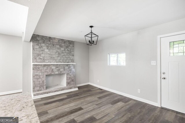 108 Holly St, Warner Robins, GA 31093 - unfurnished living room featuring plenty of natural light, dark wood-style flooring, a fireplace, and baseboards