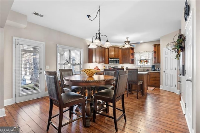 1070 Cureton Dr, Austell, GA 30106 - dining area with hardwood / wood-style floors, a ceiling fan, and a chandelier