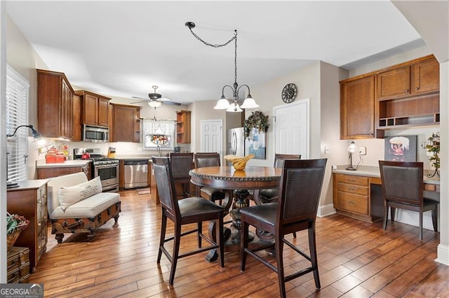 1070 Cureton Dr, Austell, GA 30106 - dining space with wood-type flooring, a chandelier, ceiling fan, and a desk