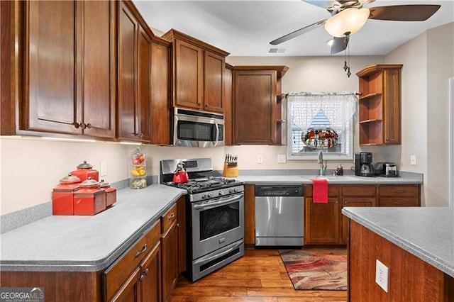 1070 Cureton Dr, Austell, GA 30106 - kitchen featuring stainless steel appliances, wood finished floors, open shelves, ceiling fan, and light countertops