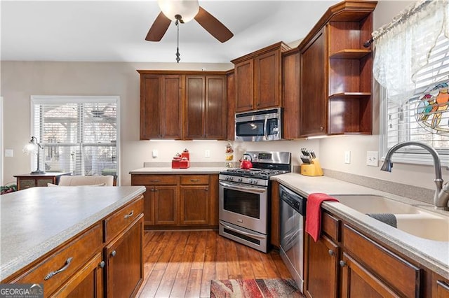 1070 Cureton Dr, Austell, GA 30106 - kitchen featuring appliances with stainless steel finishes, open shelves, ceiling fan, and healthy amount of natural light