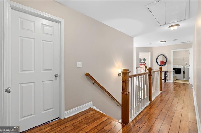1070 Cureton Dr, Austell, GA 30106 - hall featuring an upstairs landing, attic access, independent washer and dryer, and light wood-style flooring
