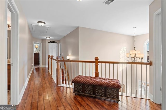 1070 Cureton Dr, Austell, GA 30106 - hall featuring hardwood / wood-style floors, a chandelier, an upstairs landing, and attic access